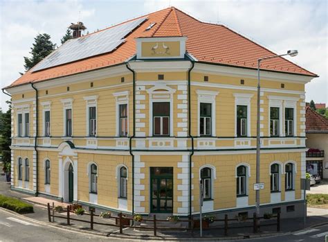Sárga homlokzatú ház ívelt tetőformával - látvány
